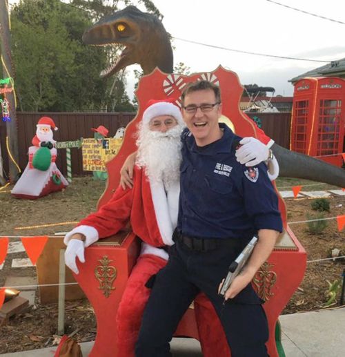 A firemen posing for a photograph with Santa outside the family's house (A Current Affair)