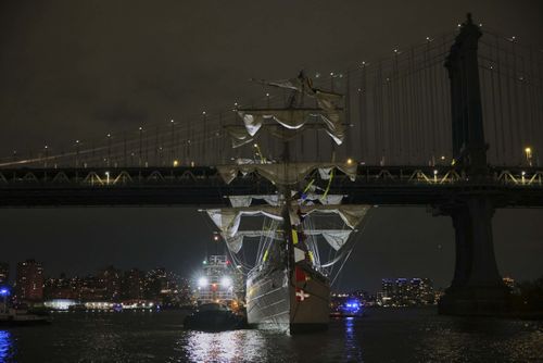 A tug boat helps stabilize the CuauhtÃ©moc, a masted Mexican Navy training ship as it sits stranded near the Manhattan Bridge after colliding with the Brooklyn Bridge.