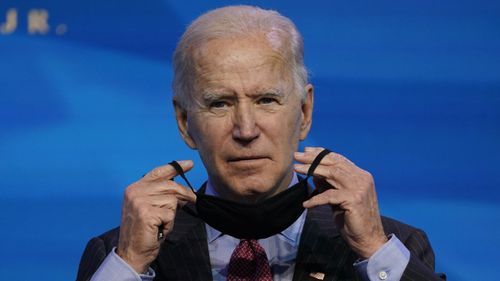 President-elect Joe Biden puts on his mask.