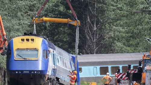 A sling on a crane is used to move part of the XPT train that derailed in Wallan North, 45km north of Melbourne, Sunday, February 23, 2020.
