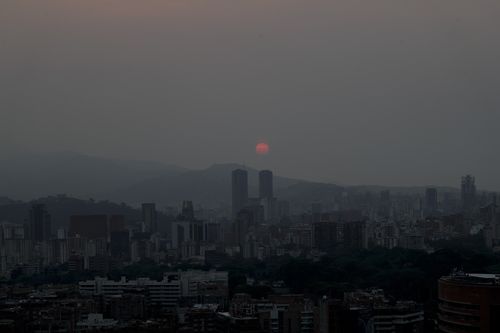 As the sun sets each night, vast stretches of the country are covered in pitch darkness as rolling blackouts continue to wreak havoc on Venezuela. (AP Photo/Natacha Pisarenko)