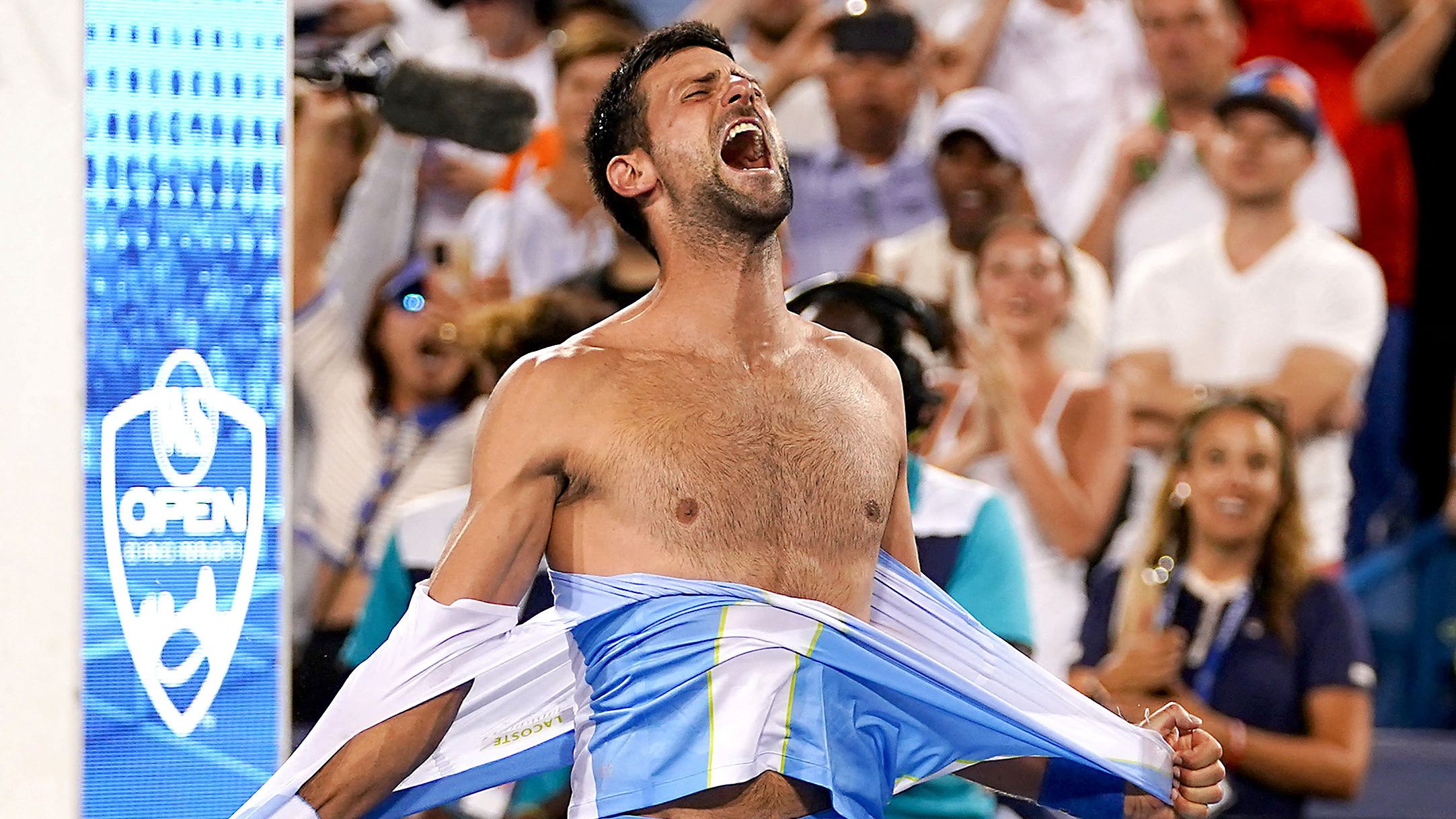 Novak Djokovic rips his shirt in celebration after defeating Carlos Alcaraz at the conclusion of the men&#x27;s singles final of the Western &amp; Southern Open tennis tournament at Lindner Family Tennis Center.