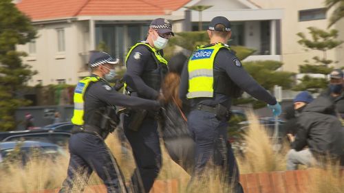 Protesters chanted slogans like "together, united, we'll never be divided" and at least a dozen arrests were made, according to The Age.