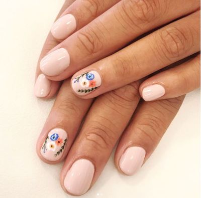 A nude-colored nail with a floral twist