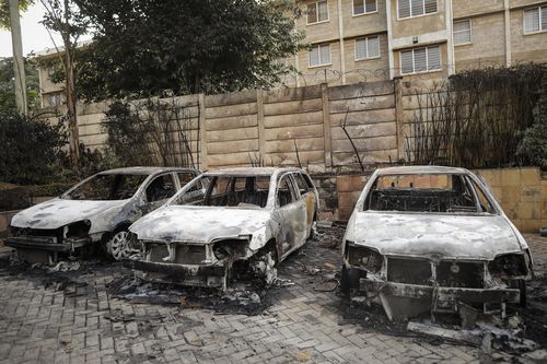 Cars were blown up outside the luxury complex.