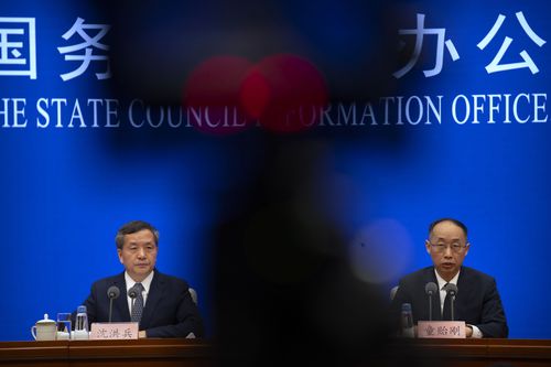 Shen Hongbing, the director of the Chinese Centre for Disease Control and Prevention listens as Tong Yigang, dean of the College of Life Science and Technology at Beijing University of Chemical Technology, speaks at a press conference on the origins of COVID-19 at the State Council Information Office in Beijing, Saturday, April 8, 2023 