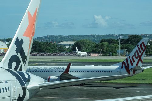 Jetstar and Virgin Australia jets on the tarmac at Gusti Ngurah Rai Airport in Denpasar, Bali.  