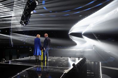 King Charles III and Camilla, Queen Consort stand on the stage after switching on stage lighting as they visit the host venue of this year's Eurovision Song Contest, the M&S Bank Arena in Liverpool on April 26, 2023 in Liverpool