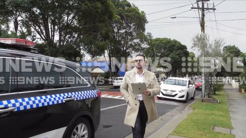 The property developer was glued to his iPad. Picture: 9NEWS