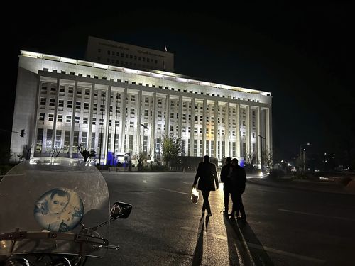 Syrian citizens walk in front the building of the Syrian Central Bank in Damascus, Syria, Saturday, Dec. 7, 2024. (AP Photo/Omar Sanadiki)