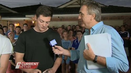 Brady Halls (right) with Jarrod as he and his two brothers learn enough money has been raised for them to buy their parent's house.