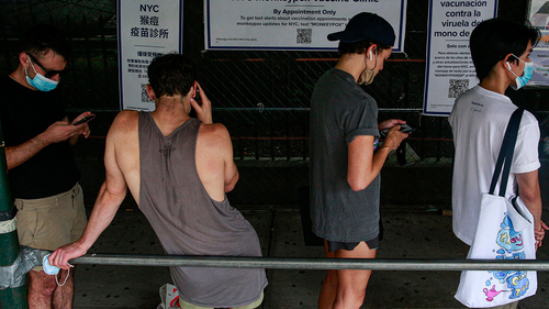 People wait in line to recieve the Monkeypox vaccine before the opening of a new mass vaccination site at the Bushwick Education Campus in Brooklyn on July 17, 2022, in New York City.