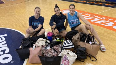 Rocci and other members of the Southside Flyers with bags of essentials they donated for the 'It's In The Bag' campaign.
