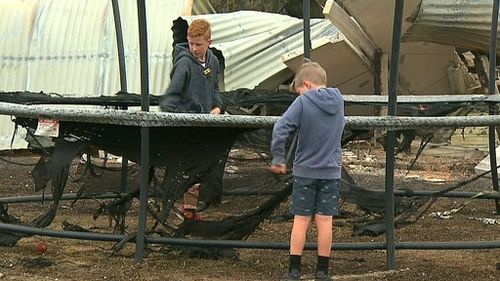 Their young daughter said that for her next birthday, she'll be asking for new trampoline after hers was burned. (9NEWS)