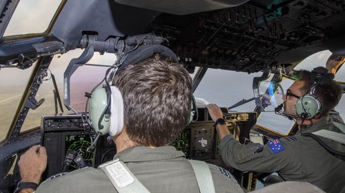 No. 37 Squadron pilots Flight Lieutenant Jack Woodrow (left) and Flying Officer John Newell fly along the coastline of Tonga to assess damage after the eruption of the Hunga-Tonga-Hunga-Ha'apai volcano.