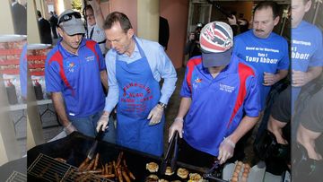 Prime Minister Tony Abbott helping with the sausage sizzle during the 2010 Federal Election. (AAP)