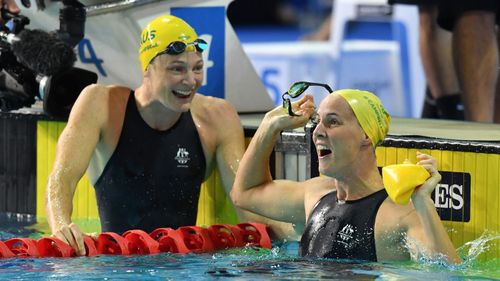 Bronte Campbell celebrates, as her sister Cate Campbell looks on, after winning the women's 100m freestyle final on day five. 