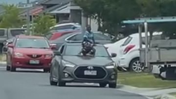 A child has been caught on camera hanging onto a moving car&#x27;s windshield in Pakenham, Melbourne.