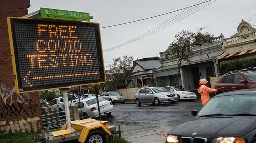 Cars enter a drive through COVID testing site in Brunswick in Melbourne.