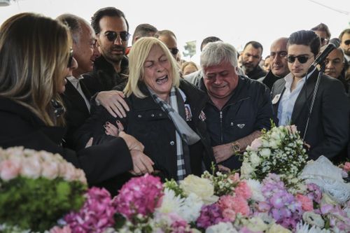 Ms Basaran's father Huseyin Basaran and other family members weep at her funeral. (Getty)