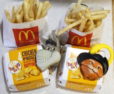 Two McDonald's Happy Meal with toy watches fashioned after the characters Donkey and Puss in Boots from the movie "Shrek Forever After" are pictured in Los Angeles June 22, 2010. A U.S. consumer group wants McDonald's Corp to stop using Happy Meal toys to lure children into its restaurants and has threatened to sue if the world's biggest hamburger chain does not comply within 30 days. REUTERS/Mario Anzuoni (UNITED STATES - Tags: FOOD CRIME LAW BUSINESS)