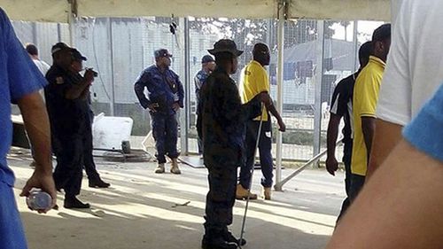 Police enter the detention centre on Thursday, ratcheting pressure on more than 300 asylum seekers to abandon the decommisioned camp. (Refugee Action Coalition/AP)