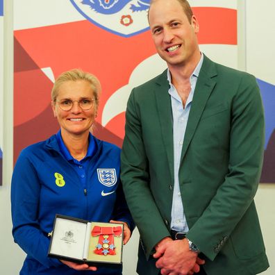 Prince William, Prince of Wales and President of The Football Association, gives an honorary CBE to England manager Sarina Wiegman during a visit to England Women's team to wish them luck ahead of the 2023 FIFA Women's World Cup at St Georges Park on June 20, 2023 in Burton-upon-Trent, England 