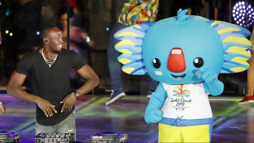 Sprinting champion Usain Bolt with mascot Borobi at the Gold Cost Commonwealth Games closing ceremony.