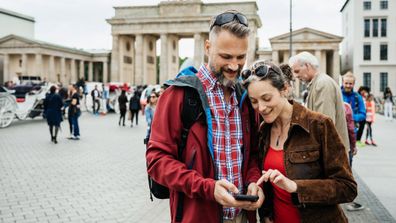 A couple taking a photo in Europe together.