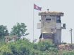 A North Korean soldier stands at the North&#x27;s military guard post as a North Korean flag flutters in the wind, seen from Paju, South Korea, on June 26, 2024.