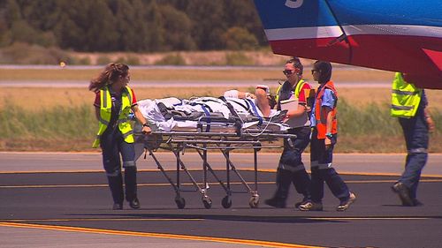 A passenger is transferred from a Royal Flying Doctor Service plane before being taken to Royal Adelaide Hospital. (9NEWS)