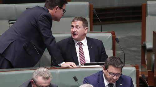 Minister David Littleproud approaches the backbench for a discussion with Nationals MP Llew O'Brien during Question Time at Parliament House, in 2019.