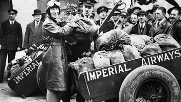 Charles Kingsford Smith on arrival at Croydon, England, with some of the fifty thousand letters of the first Christmas airmail from Australia to England, 1931