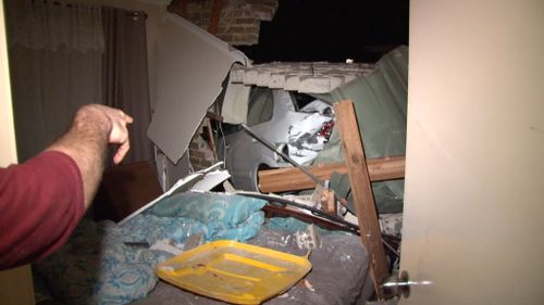 The woman was sleeping in her bedroom when the car crashed through the wall. (9NEWS)