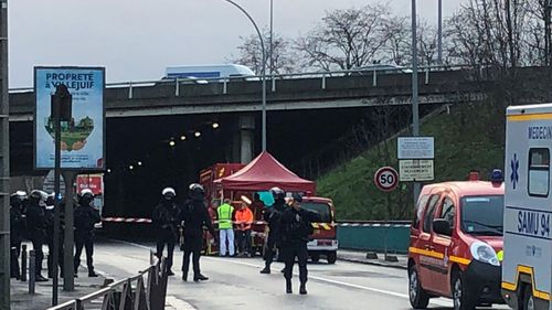 Police officers secure the area after a man attacked passerby Friday Jan.3, 2020 in Villejuif, south of Paris. A man armed with a knife attacked passers-by Friday in a southern Paris park, injuring some, before being shot by police, French officials said.