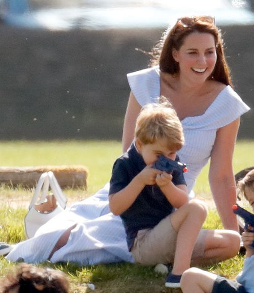 Prince George happily playing with a toy pistol in front of his mum at a polo match in Gloucestershire recently. Picture: Getty