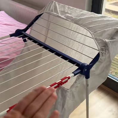 German woman shares a fitted sheet drying hack for clothes airers indoors