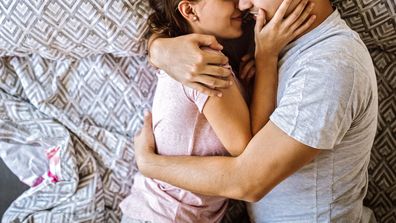 Couple cuddling in bed