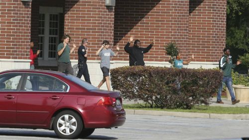 Students are led out of Forest High School with their hands up. (AP)