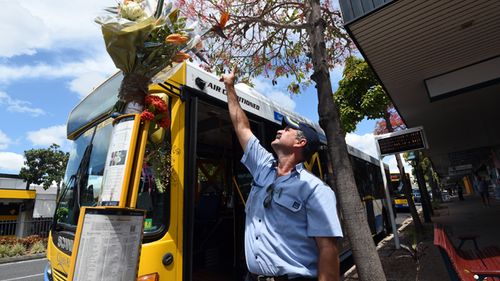 A bus driver pays his respects to fellow driver Manmeet Sharma at the bus stop where he was murdered in Morooka, Brisbane