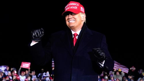 President Donald Trump dances after a campaign rally at Gerald R. Ford International Airport