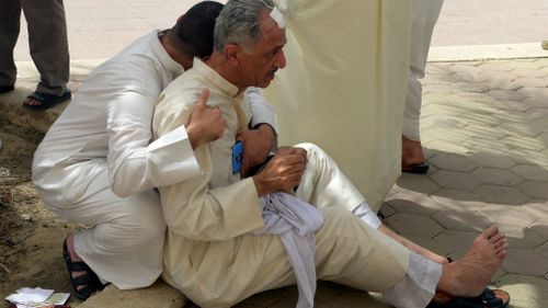 Kuwaiti worshippers react following a blast at Imam Sadiq Mosque. (AAP)