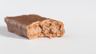 Tim Tam with bite taken out of it.