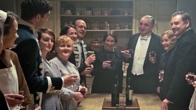 Downton Abbey the movie - downstairs group shot toast visit to King and Queen 