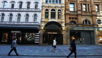 Pedestrians in a very quiet and closed Pitt Street shopping mall in Sydney.