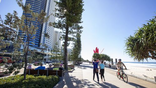 People walk along the Esplanade at Surfers Paradise on July 15, 2020 in Gold Coast, Australia. Pop up testing clinics have been established in Queensland tourist regions in a bid to detect any potential COVID-19 cases.