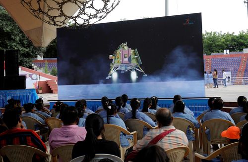People watch a live stream of Chandrayaan-3 spacecraft's landing on the moon, inside an auditorium of Gujarat Science City in Ahmedabad, India, August 23, 2023. 