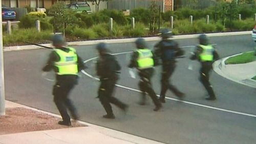 Police prepare to confront the partygoers. (9NEWS)