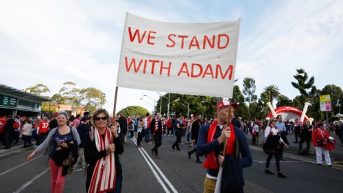 Swans fans arriving at the SCG with banners. (AAP)