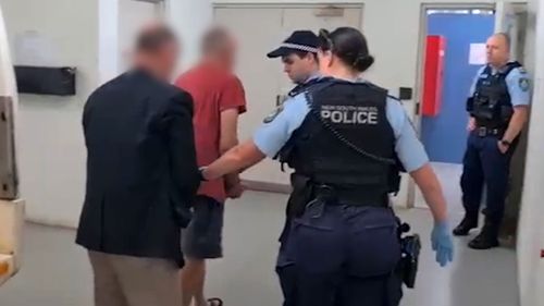 Two men, pictured in the black jacket at red shirt, were arrested and taken to Leeton Police Station today.